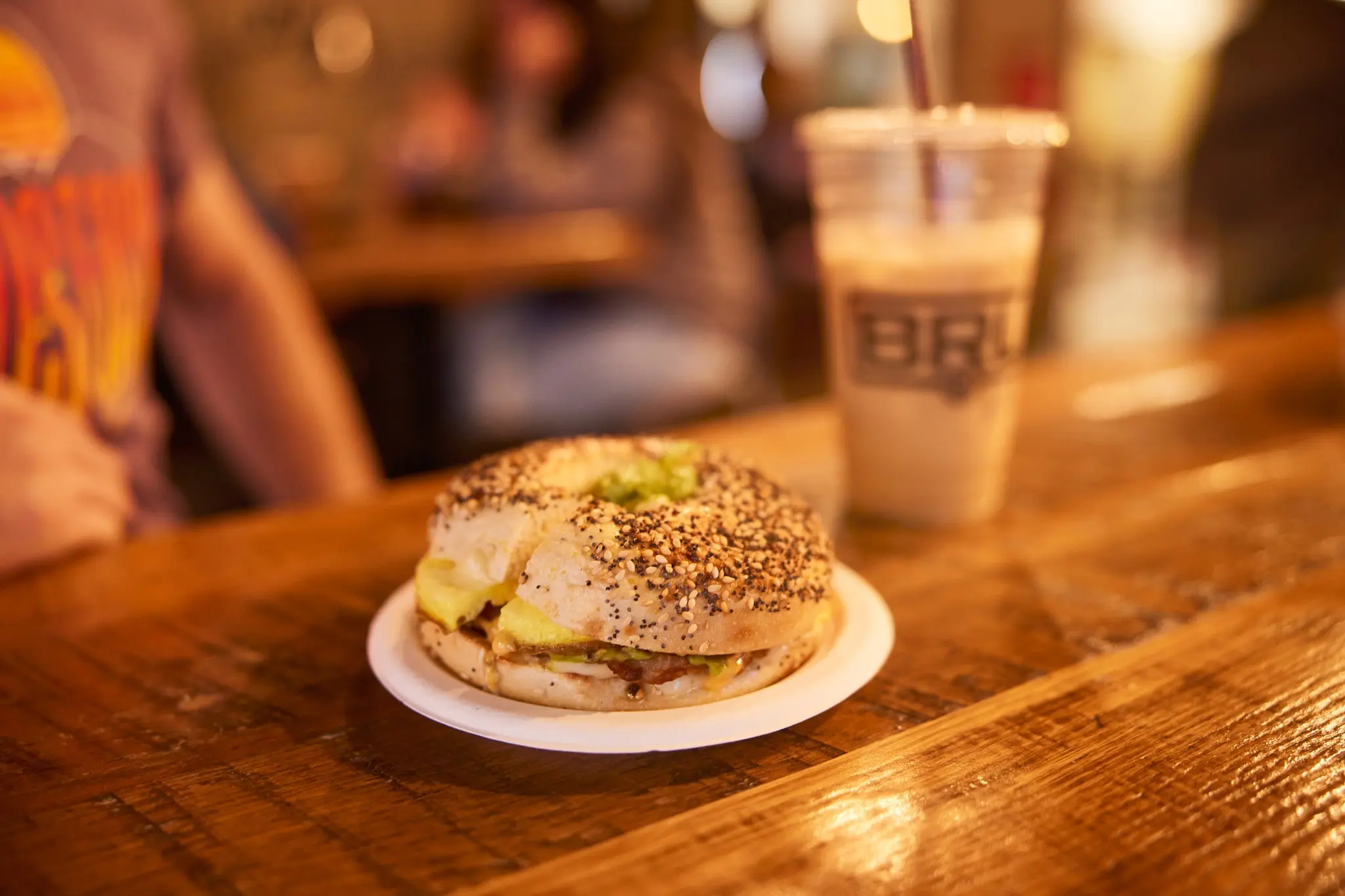 Bagel egg sandwich with an iced coffee.